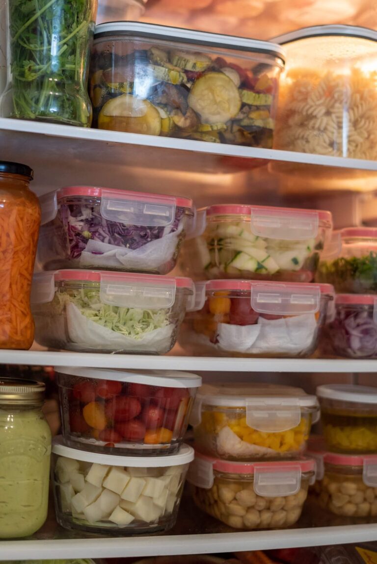 A clean, well-organized fridge with labeled containers and visible food zones.