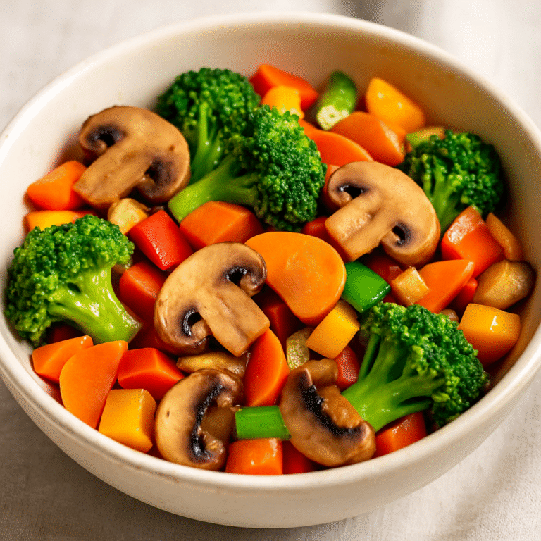 Bowl of colorful stir-fried vegetables with broccoli, carrots, mushrooms, and bell peppers, showing how to reuse perishable ingredients