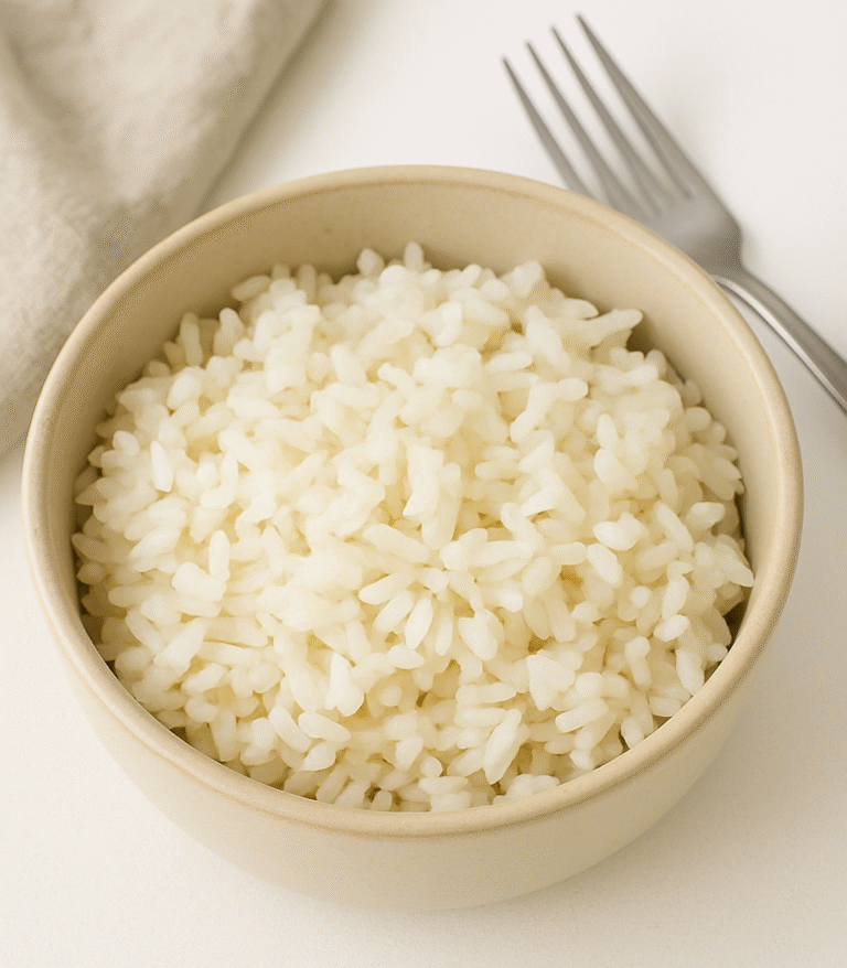 A bowl of perfectly cooked rice on a minimalist solo dinner setup